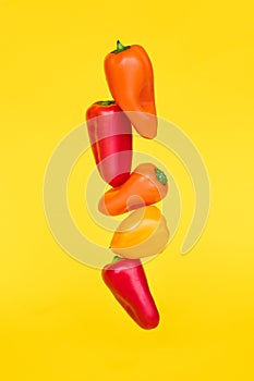 Cooking concept. Colored peppers on a yellow background. Vegetables on color background