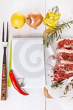 Cooking concept. Recipe book and ingredients for cooking meat