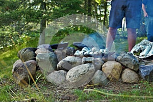 Cooking corn on the cob over a camp fire