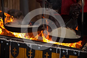 Cooking crepes in an ancient way.