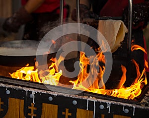 Cooking crepes in an ancient way.