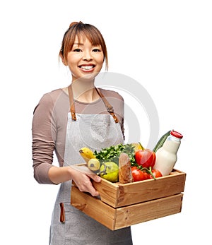happy smiling female chef with food in wooden box