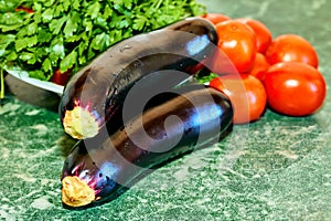 Cooking delicious and healthy food.Eggplants, tomatoes and parsley.