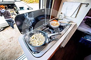 Cooking dinner or lunch in campervan, motorhome or RV