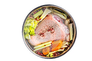 Cooking of Eisbein from Raw pork Hock ham, shank with vegetables and herbs. Isolated on white background.