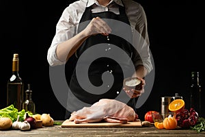 Cooking a festive duck for the Christmas, New Year`s Eve dinner chef.Preparing fresh duck. Horizontal photo with dark black