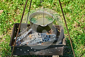 Cooking on the fire. Spring forest. Camping