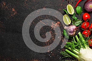 Cooking food background. Fresh vegetables, spices and herbs on black stone table. Top view with copy space. Vegan food