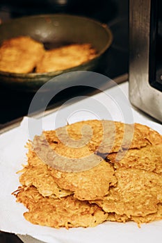 Cooking food on an electric stove. Draniki are fried in a frying pan photo