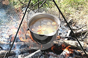 Cooking food in a kettle on a firewood fire