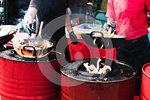 Cooking food in pans at a street festival