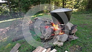 Cooking food in pot over campfire outdoor