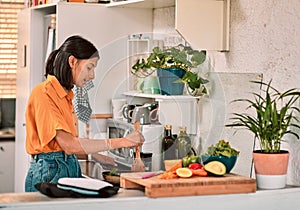 Cooking, food and recipe with woman in kitchen of home for preparation of diet, health or nutrition. Ingredients, stove