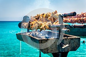 Cooking fresh Cypriot souvla on the sea