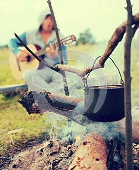 Cooking fresh food in cauldron at camp on open fire