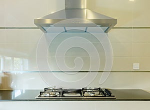 Cooking gas stove with hood in kitchen