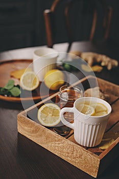 Cooking ginger, lemon and honey hot tea at home.