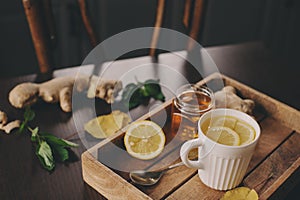 Cooking ginger, lemon and honey hot tea at home.