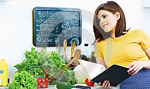 Cooking girl with recipe book.