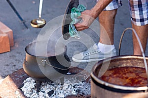 Cooking Goulash, seasoned spicy stew of meat and vegetables