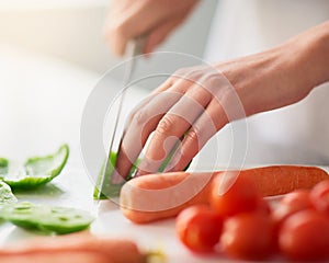 Cooking, hands and knife for vegetables on counter in kitchen of home for diet, health or nutrition. Chef, food and