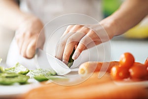 Cooking, hands and knife for vegetables on kitchen counter in home for diet, health or nutrition. Chef, food recipe and