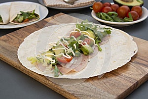 Cooking healthy avocado and vegetables burrito, wraps, rolles. Healthy breakfast or snack. Avocado sandwich. Copy space