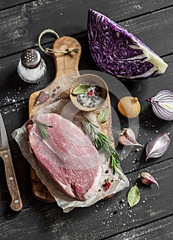 Cooking healthy food - meat, red cabbage, spices and herbs. Raw ingredients.