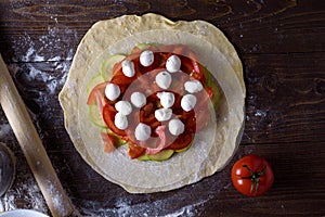 Cooking homemade biscuits, pizza with vegetables and cheese. A vegetarian dish, healthy meal.