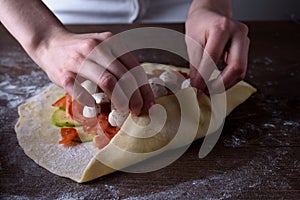 Cooking homemade biscuits, pizza with vegetables and cheese. A vegetarian dish, healthy meal.