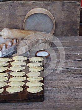 Cooking homemade dumplings.In the kitchen, there is a cutting Board, ready-made dumplings with ingredients for making dough and