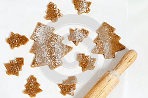 Cooking homemade Gingerbread Cookies. Christmas tree biscuits on paper for baking
