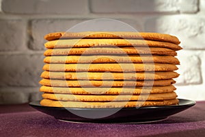 Cooking honey cake at home. Round baked cake layers stacked on a plate