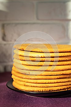 Cooking honey cake at home. Round baked cake layers stacked on a plate