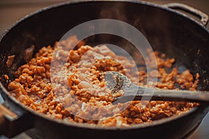 Cooking indian daal or beans in big pan. Hot meal with spices masala photo