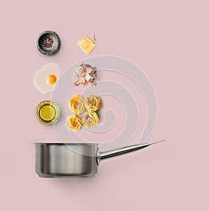 Cooking ingredients for italian food, carbonara, on pink background