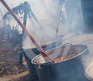 Cooking in iron cauldrons on open fire