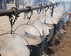 Cooking in iron cauldrons on open fire