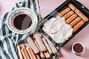 Cooking Italian Dessert with cocoa, coffee and mascarpone cheese Tiramisu and all the necessary food ingredients and utensils.