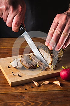 Cooking juicy beef steak by chef hands on dark black background with copy space for text menu or recipe