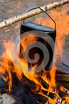 Cooking in a kettle on a fire.