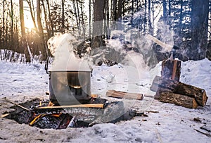 Cooking in a kettle on a fire in the winter