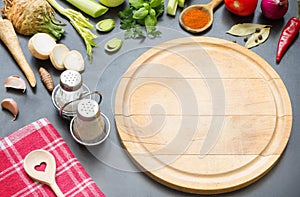 Cooking in the kitchen food background concept with spices vegetables and cutting board