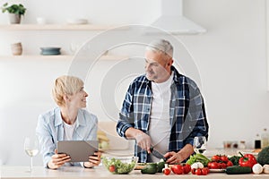 Cooking in kitchen together, searching recipe in internet, watch online blog