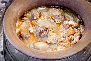 Cooking knuckle, hock, ham hock, pork knees, pork shoulder and cabbage in in earthy boiler-pans