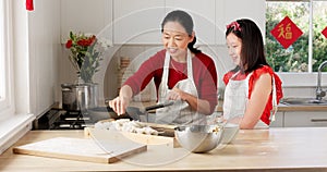 Cooking, learning and asian with mother and girl in kitchen for Chinese lunar new year festival celebration. Food