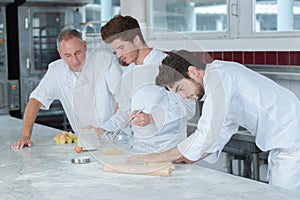 Cooking lesson with three apprentices