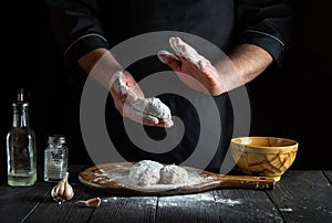 Cooking meat cutlets in flour by the chef is hands in the kitchen. The idea of preparing a delicious breakfast or lunc