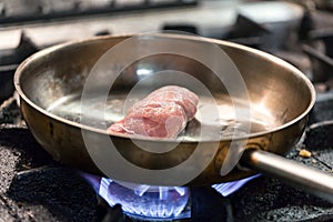 Cooking meat in a frying pan