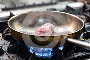 Cooking meat in a frying pan